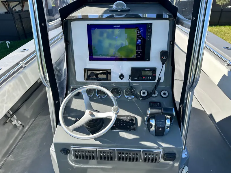 Slide: The Image of 2005 Contender 36 Open boat dashboard with navigation system and controls. - 11