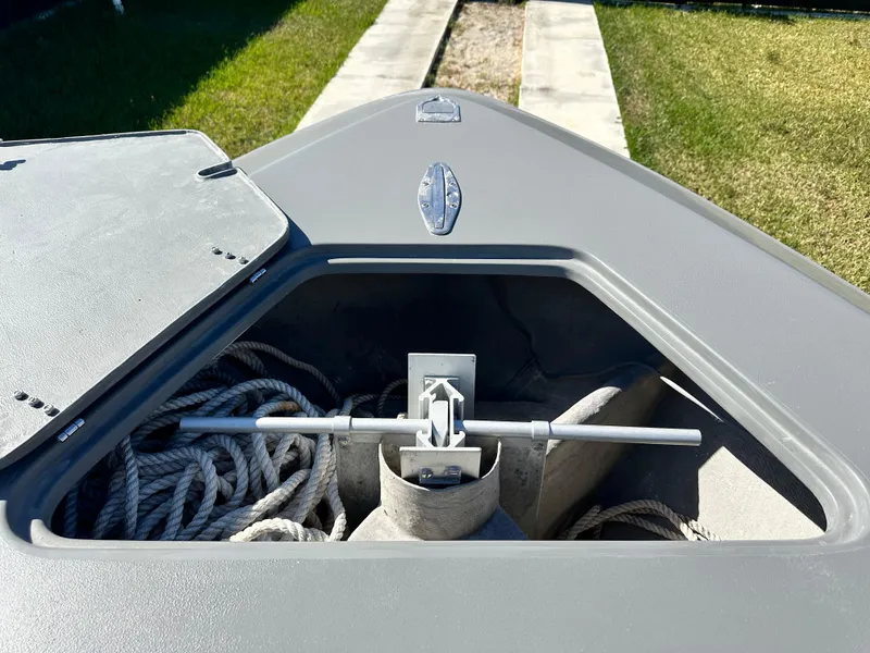 Slide: The Image of Anchor storage compartment on 2005 Contender 36 Open boat, featuring ropes and anchor. - 14