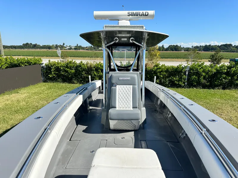 Slide: The Image of 2005 Contender 36 Open boat with Simrad electronics, docked on grassy area. - 17