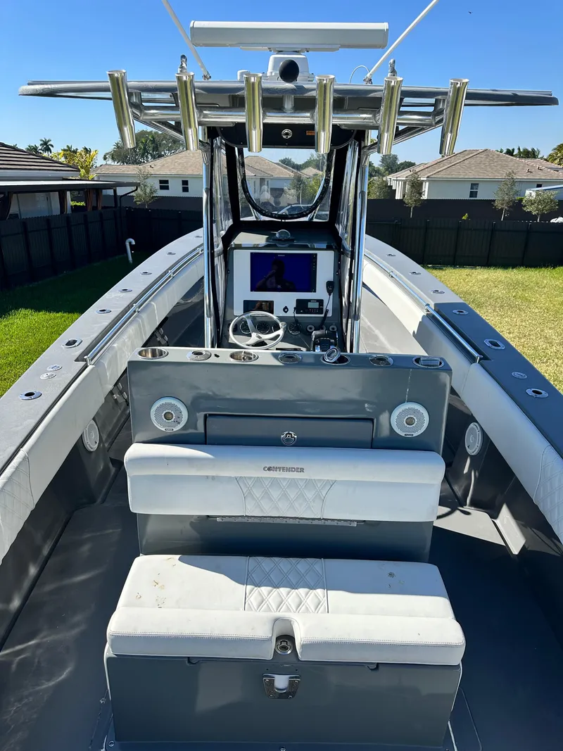 Slide: The Image of 2005 Contender 36 Open boat interior with helm and seating, parked in a residential area. - 20