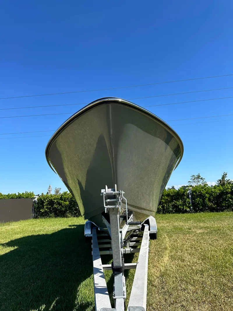 Slide: The Image of 2005 Contender 36 Open boat on trailer under clear blue sky. - 4