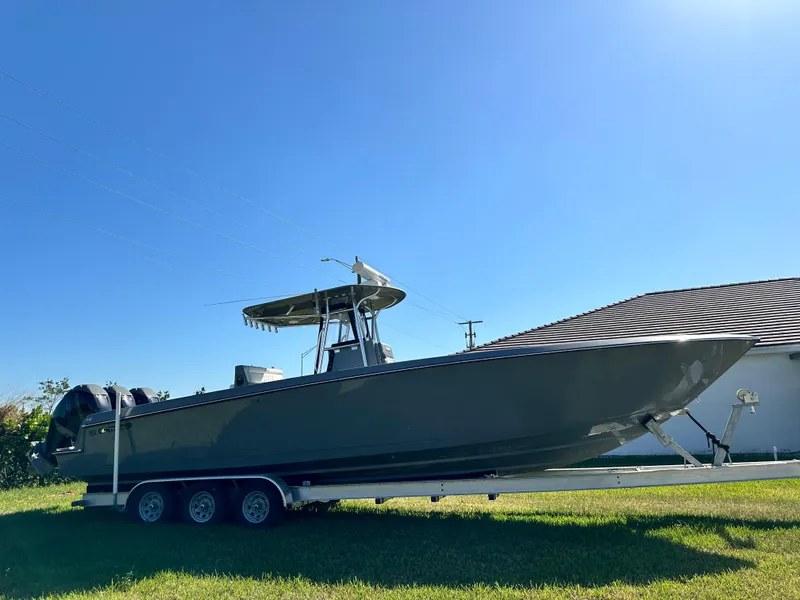 Slide: The Image of 2005 Contender 36 Open boat on trailer under clear blue sky. - 5