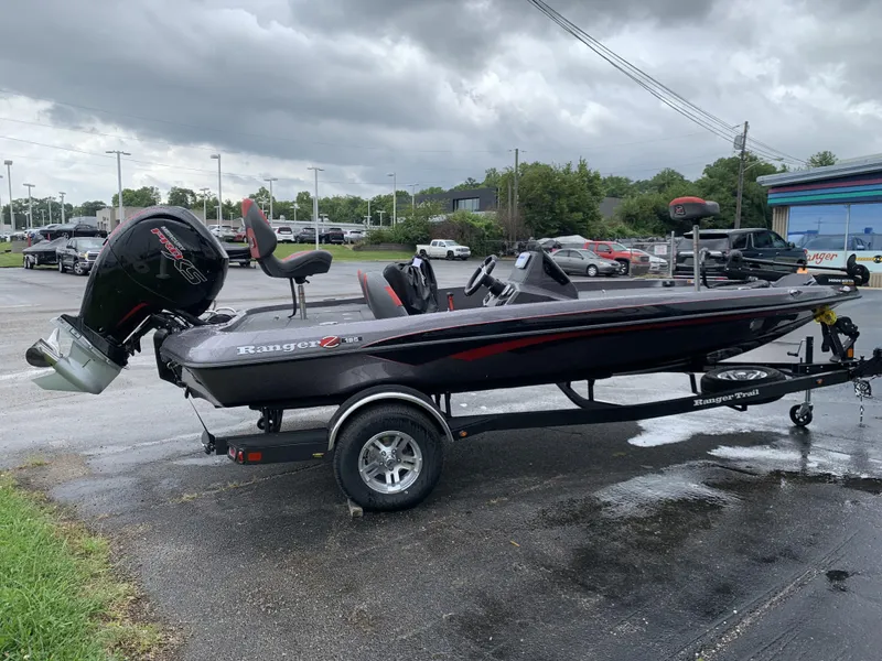 Slide: The Image of 2025 Ranger Z185 boat on trailer, parked outdoors under cloudy skies. - 3