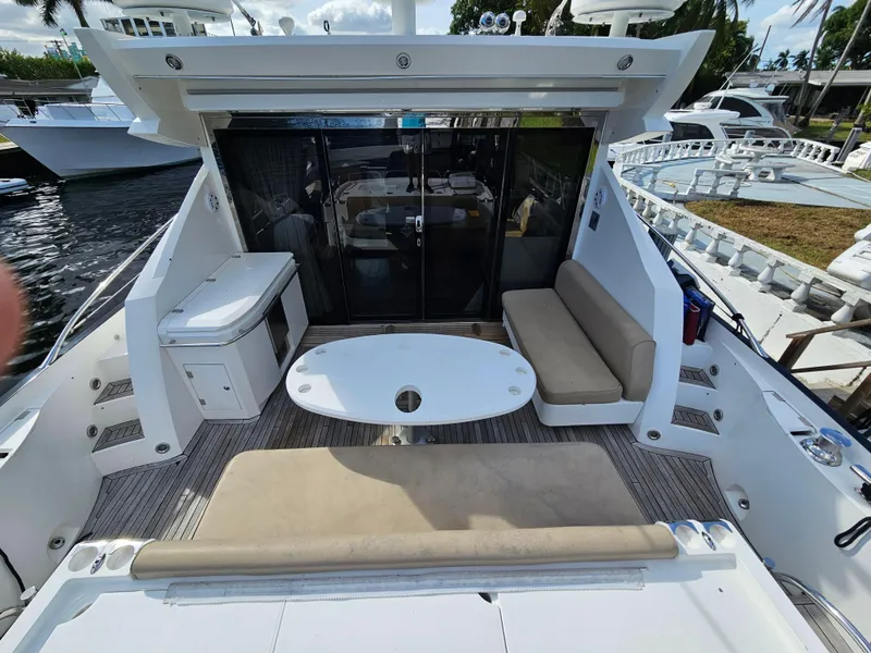 Slide: The Image of 2010 Sunseeker Predator 64 yacht deck with seating and table. - 2
