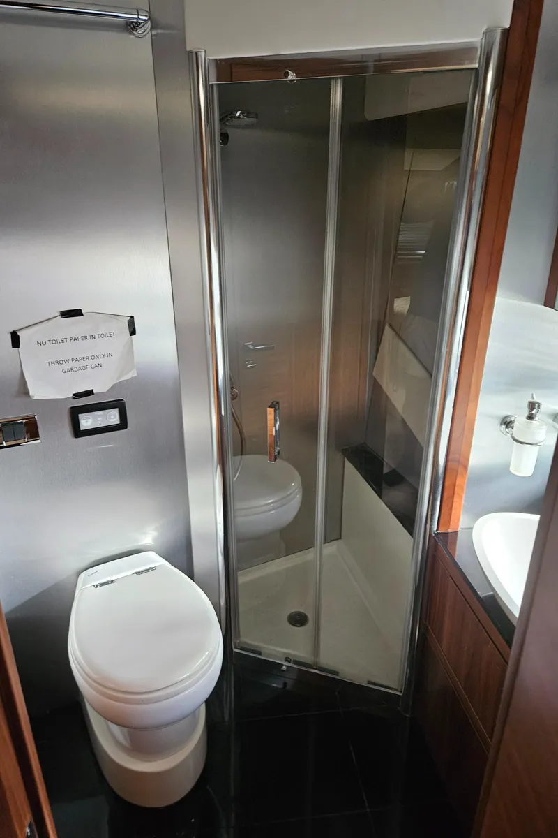 Slide: The Image of Bathroom interior of 2010 Sunseeker Predator 64 yacht, featuring shower and toilet. - 20