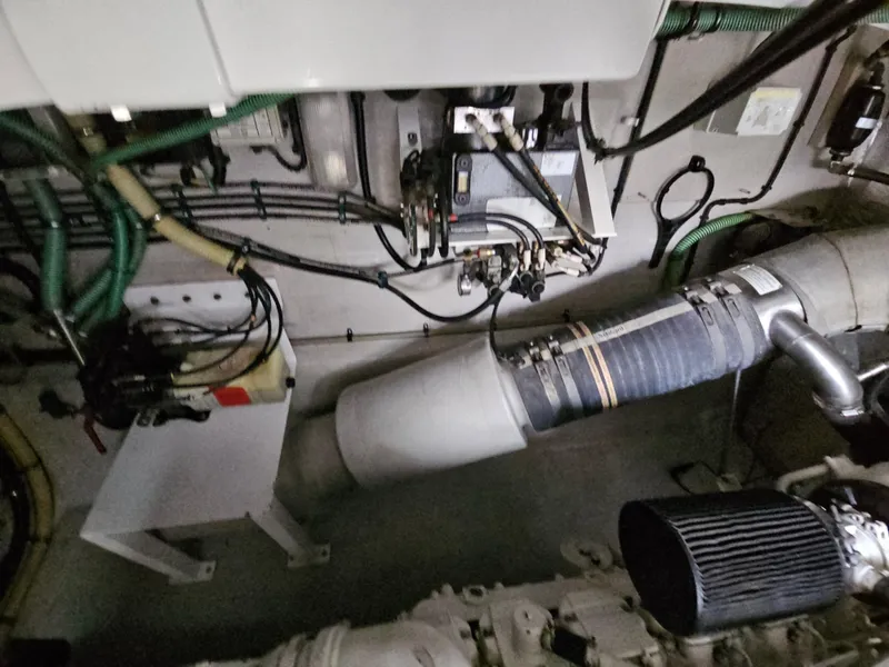 Slide: The Image of Engine room of 2010 Sunseeker Predator 64 yacht, showcasing mechanical components and wiring. - 25