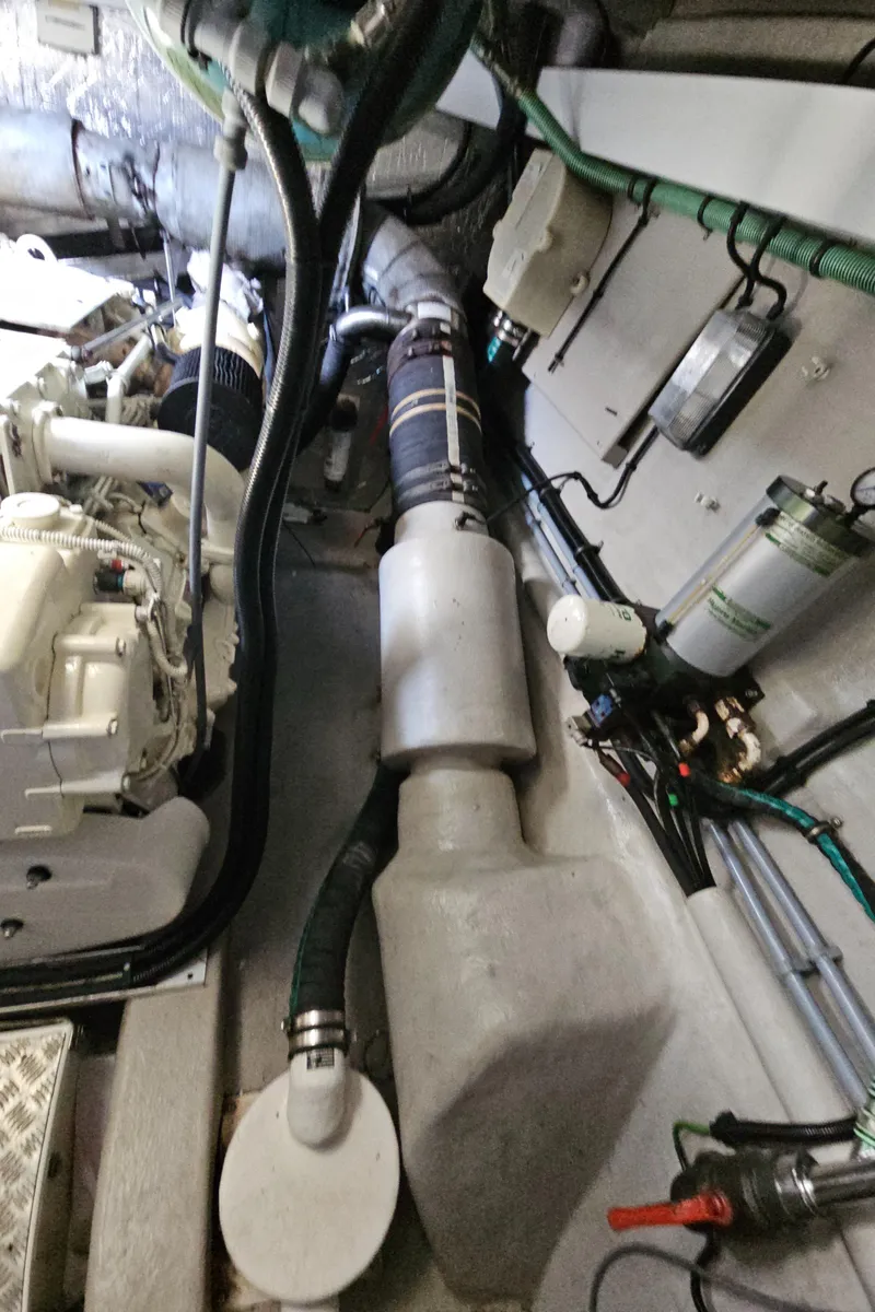 Slide: The Image of Engine room of 2010 Sunseeker Predator 64 yacht, showcasing mechanical components and piping. - 27