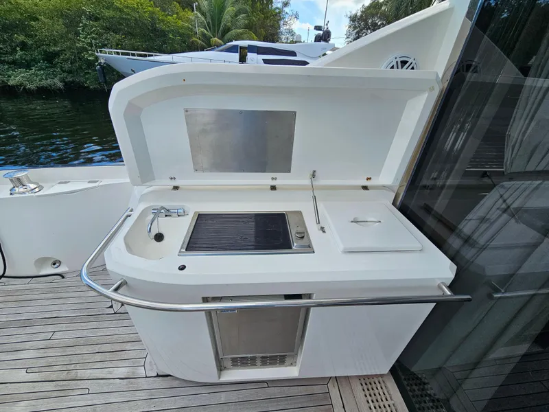 Slide: The Image of Outdoor kitchenette on 2010 Sunseeker Predator 64 yacht, featuring sink and grill. - 3