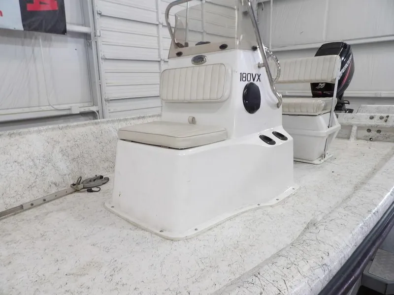 Slide: The Image of 2009 Kenner 180VX boat interior with seating and console in a garage setting. - 10