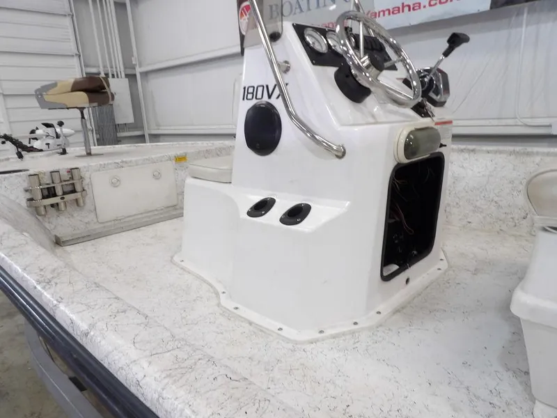 Slide: The Image of 2009 Kenner 180VX boat console with steering wheel and controls in a garage setting. - 11