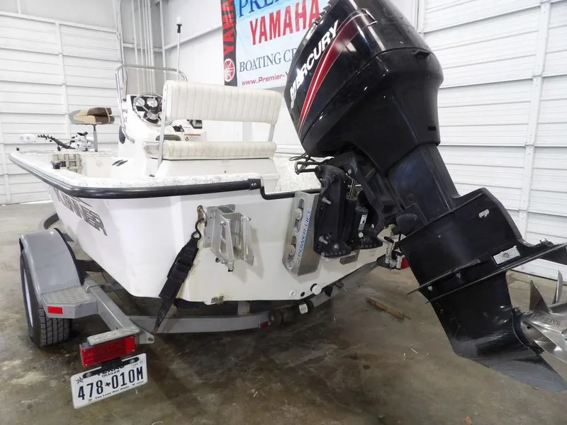 Slide: The Image of 2009 Kenner 180VX boat with Mercury outboard motor in a garage setting. - 14