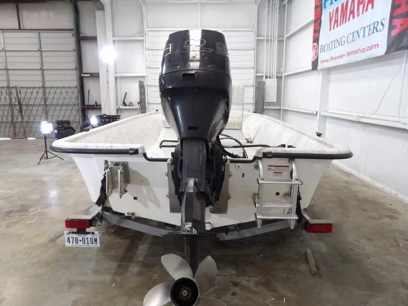 Slide: The Image of 2009 Kenner 180VX boat in a garage, rear view with outboard motor. - 15