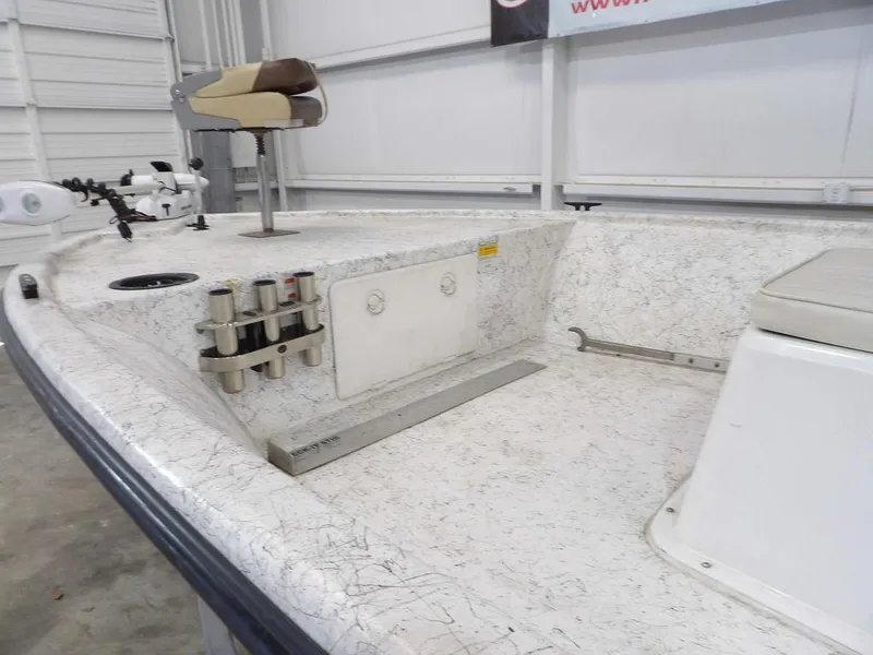 Slide: The Image of 2009 Kenner 180VX boat interior with fishing rod holders and seating. - 9