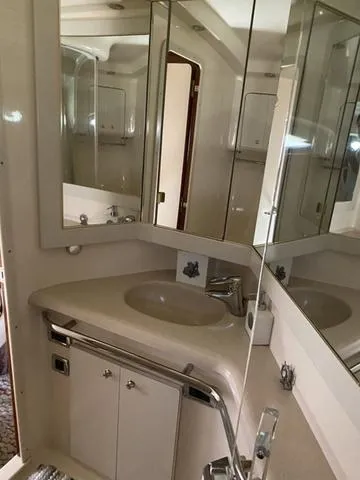 Slide: The Image of Bathroom interior of 2003 Sea Ray 550 Sundancer yacht with mirrored cabinets. - 10
