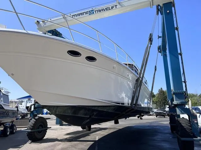 Slide: The Image of 2003 Sea Ray 550 Sundancer yacht on a marine travel lift. - 3