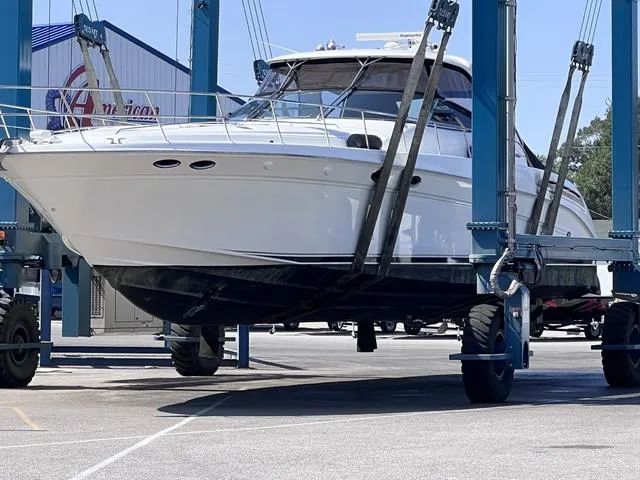 Slide: The Image of 2003 Sea Ray 550 Sundancer yacht in dry dock, ready for maintenance. - 4