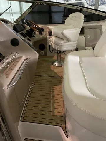 Slide: The Image of Interior of 2003 Sea Ray 550 Sundancer with luxurious seating and modern controls. - 5
