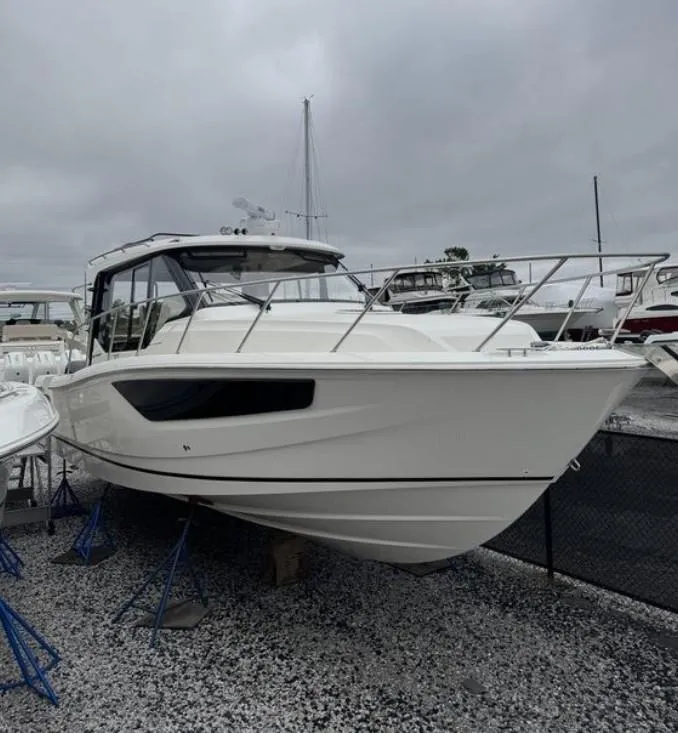 The Image of 2025 Boston Whaler 365 Conquest boat displayed on gravel lot under cloudy sky. - 0