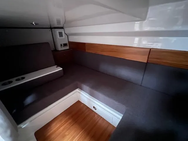 Slide: The Image of 2025 Boston Whaler 365 Conquest cabin interior with modern seating and wood accents. - 13