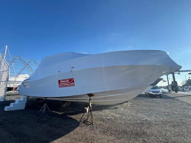 Slide: The Image of 2025 Boston Whaler 365 Conquest boat covered and elevated on stands. - 2