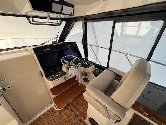 Slide: The Image of 2025 Boston Whaler 365 Conquest helm with modern controls and comfortable seating. - 3