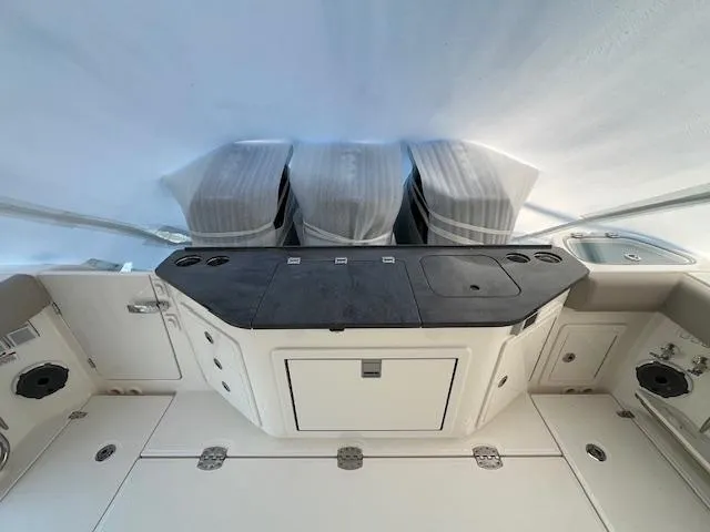 Slide: The Image of 2025 Boston Whaler 365 Conquest boat interior with modern console and storage. - 9