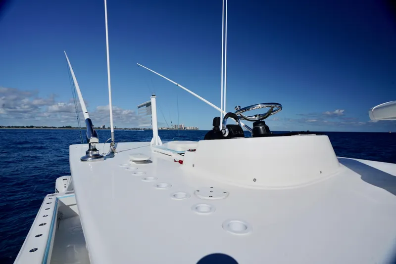 Slide: The Image of SeaHunter 46 CTS 2020 boat deck with steering wheel, ocean view, clear blue sky. - 12