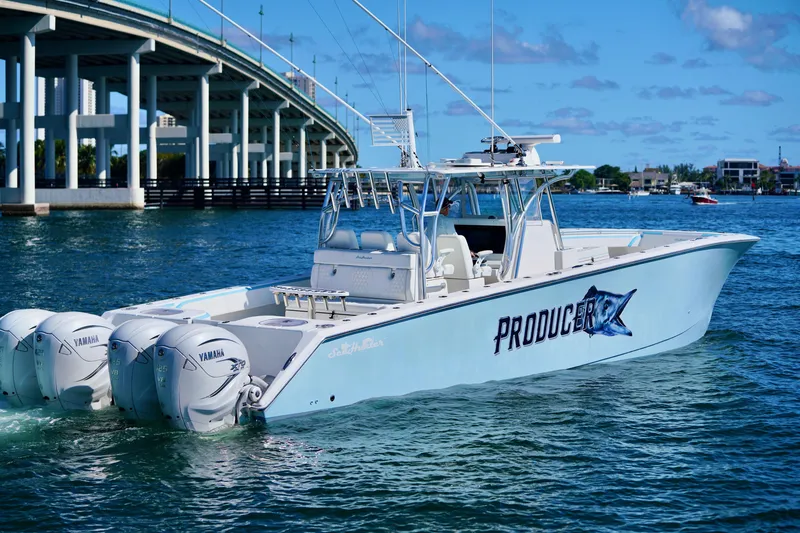 Slide: The Image of 2020 SeaHunter 46 CTS boat with Yamaha engines on water near a bridge. - 16