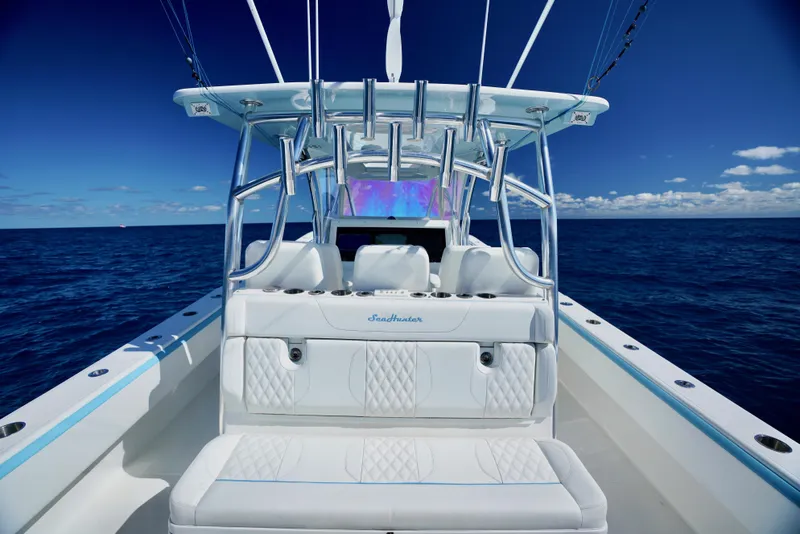 Slide: The Image of 2020 SeaHunter 46 CTS boat interior with ocean view, featuring white seating and sleek design. - 17