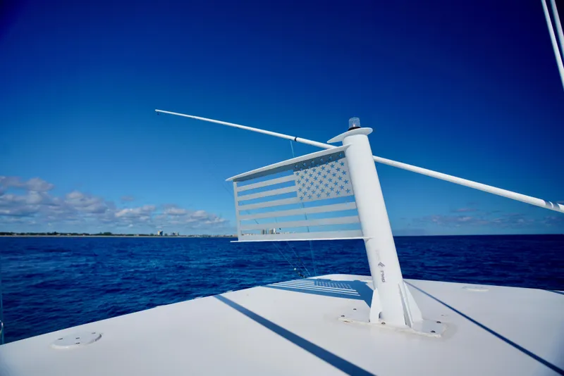 Slide: The Image of SeaHunter 46 CTS boat with American flag on open ocean, 2020 model. - 19