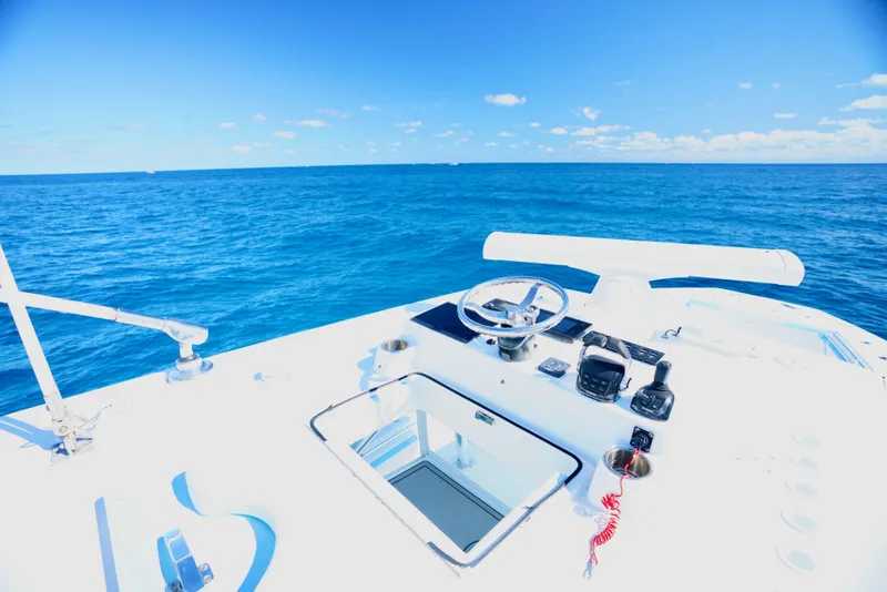 Slide: The Image of SeaHunter 46 CTS 2020 boat helm with ocean view under clear blue sky. - 20