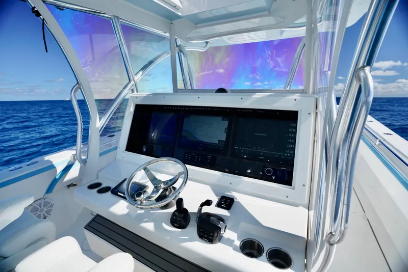 Slide: The Image of 2020 SeaHunter 46 CTS helm with advanced navigation system on open ocean. - 22