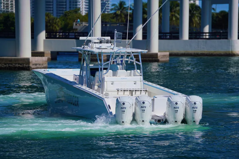 Slide: The Image of 2020 SeaHunter 46 CTS boat with four engines cruising in clear water. - 27