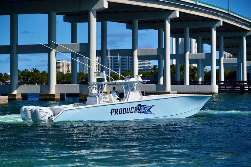 Slide: The Image of 2020 SeaHunter 46 CTS boat cruising under a bridge on a sunny day. - 28