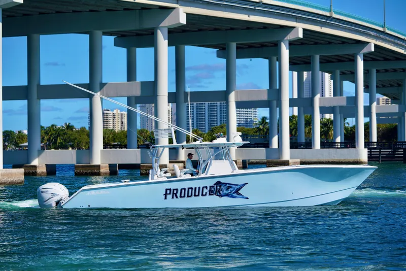 Slide: The Image of 2020 SeaHunter 46 CTS boat cruising under a bridge on a sunny day. - 29