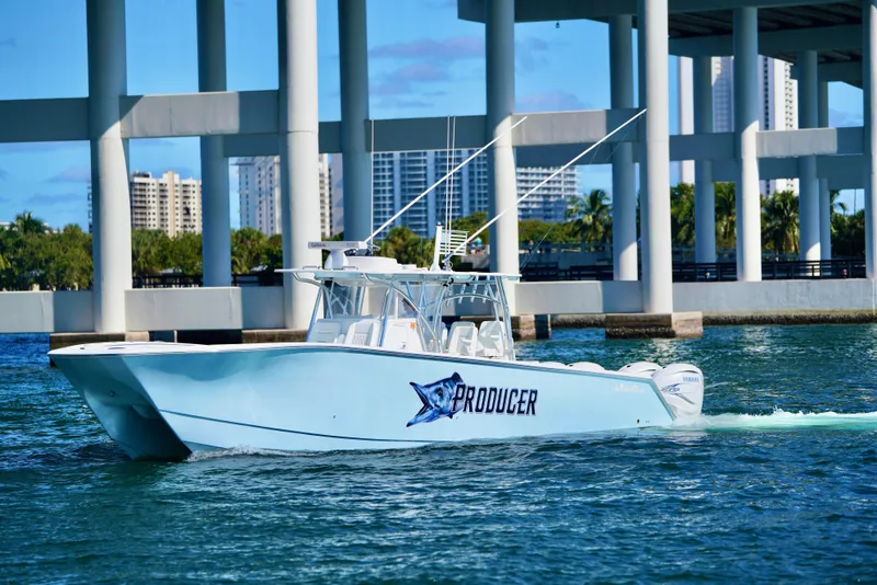 Slide: The Image of 2020 SeaHunter 46 CTS boat cruising under a bridge in sunny waters. - 31