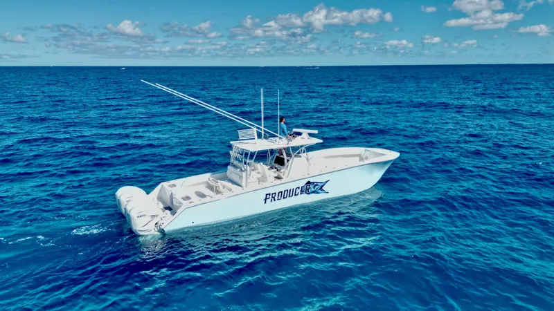 Slide: The Image of 2020 SeaHunter 46 CTS boat on open ocean under clear blue sky. - 4
