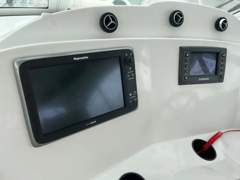 Slide: The Image of Control panel of 2004 Glacier Bay 3480 Ocean Runner with Raymarine and Evinrude displays. - 12