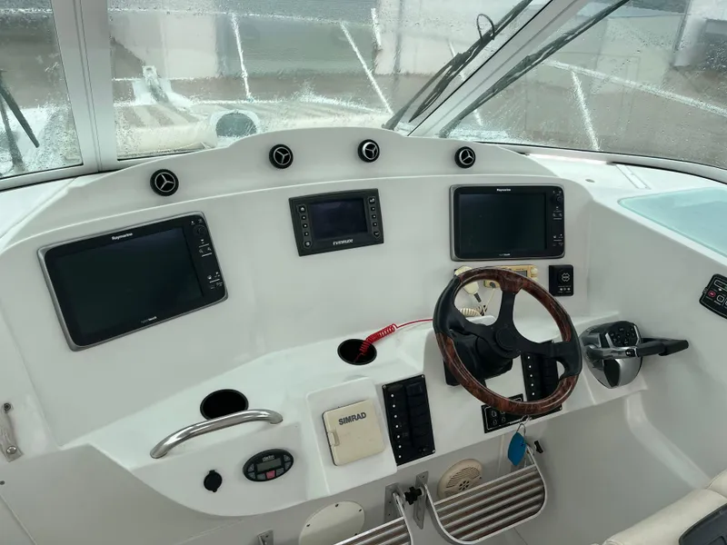 Slide: The Image of 2004 Glacier Bay 3480 Ocean Runner cockpit with navigation instruments and steering wheel. - 13