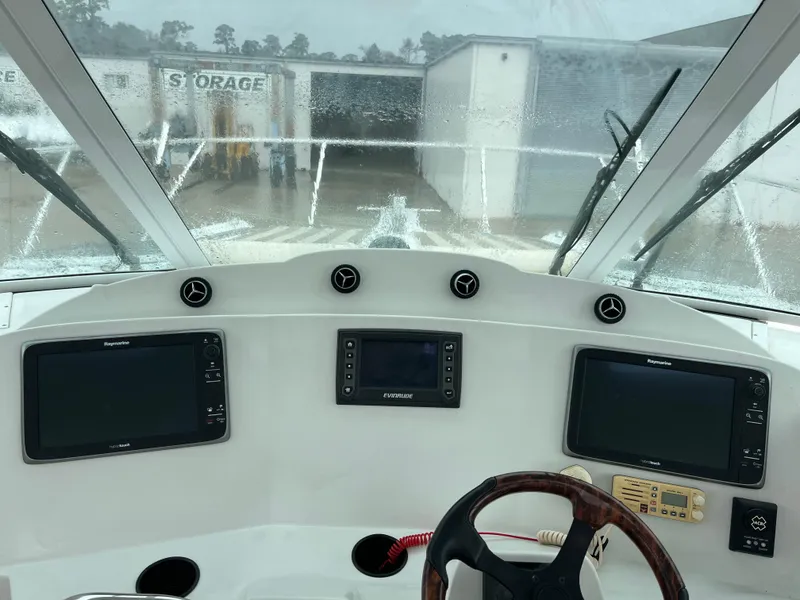 Slide: The Image of 2004 Glacier Bay 3480 Ocean Runner helm with navigation screens and steering wheel. - 14