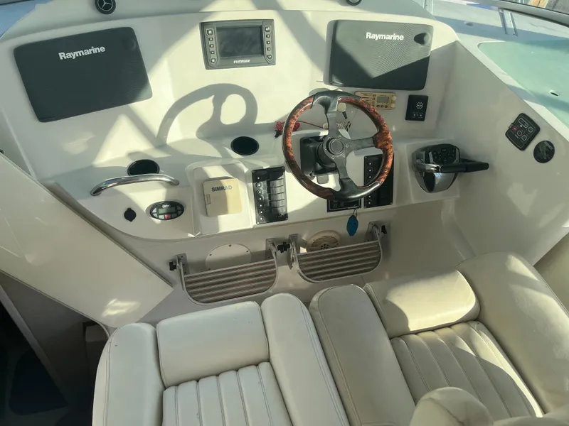 Slide: The Image of 2004 Glacier Bay 3480 Ocean Runner helm with Raymarine electronics and leather steering wheel. - 5