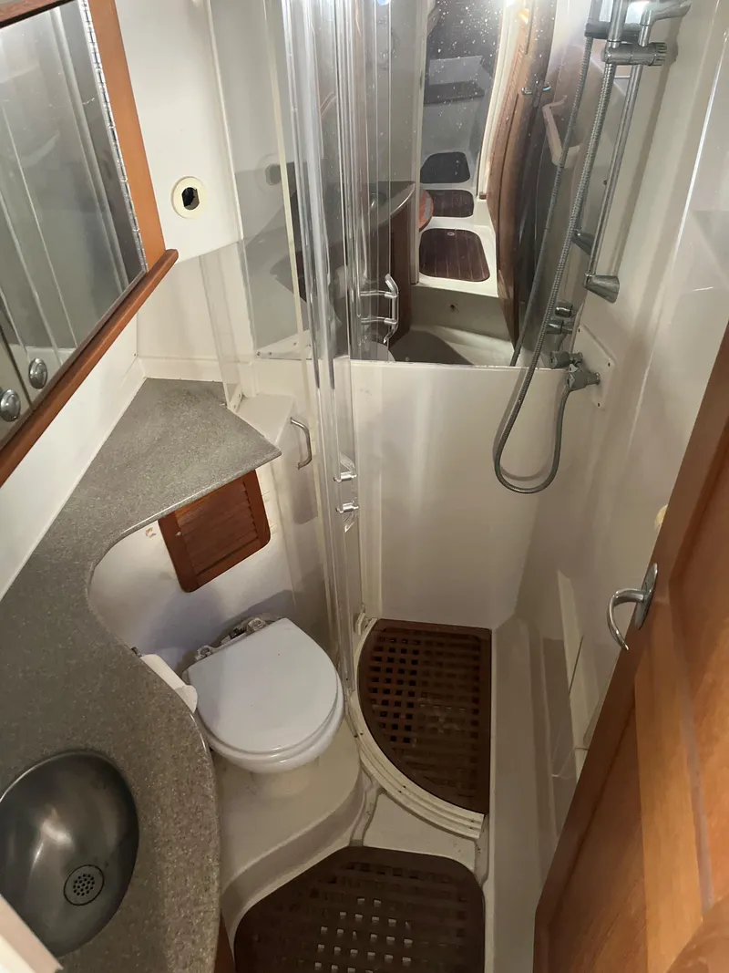 Slide: The Image of 2004 Glacier Bay 3480 Ocean Runner bathroom with shower, sink, and toilet. - 6