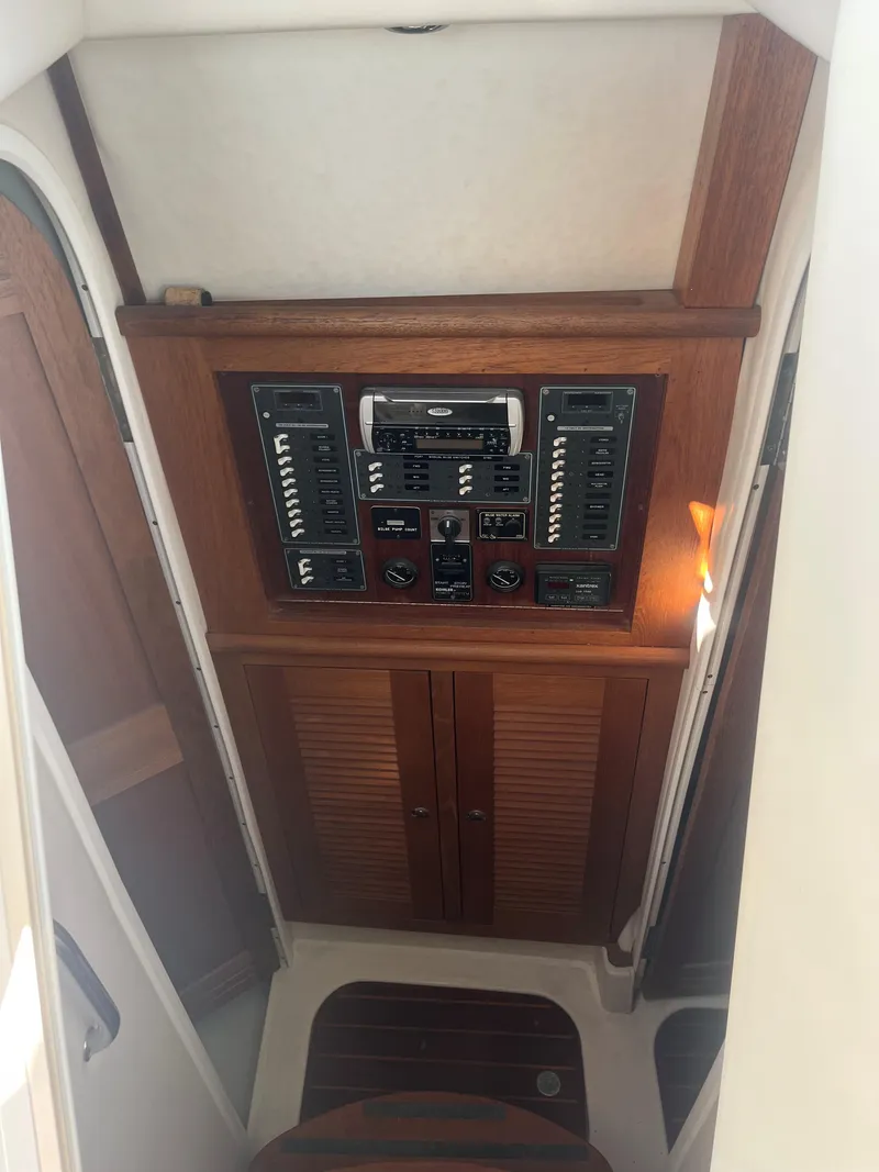 Slide: The Image of 2004 Glacier Bay 3480 Ocean Runner control panel with wooden cabinetry. - 8