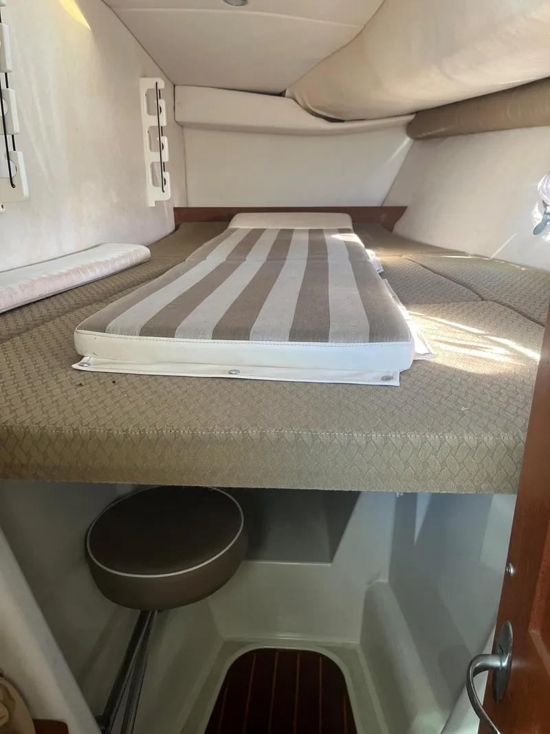 Slide: The Image of 2004 Glacier Bay 3480 Ocean Runner cabin interior with striped bedding. - 9