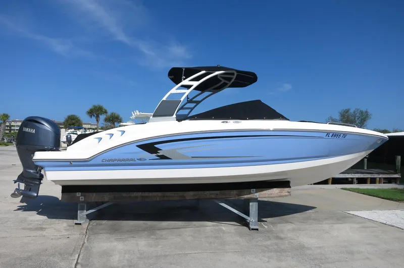 Slide: The Image of 2024 Chaparral 23 SSi OB boat on display, featuring sleek design and Yamaha outboard motor. - 1