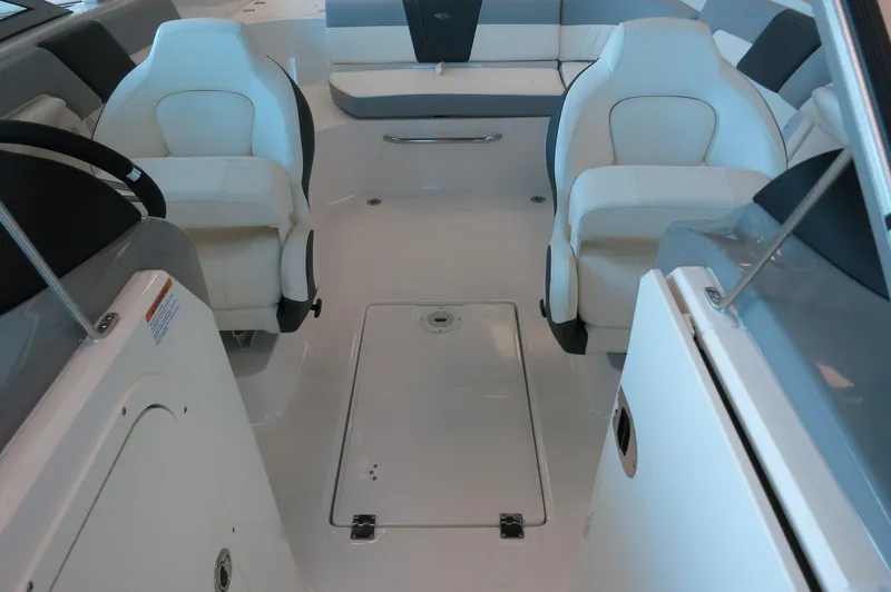 Slide: The Image of 2024 Chaparral 23 SSi OB boat interior with white seating and sleek design. - 10