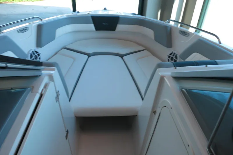 Slide: The Image of 2024 Chaparral 23 SSi OB boat interior with cushioned seating and storage compartments. - 11