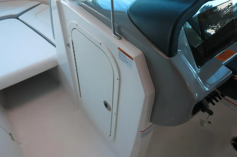 Slide: The Image of 2024 Chaparral 23 SSi OB boat interior, featuring sleek design and storage compartment. - 12