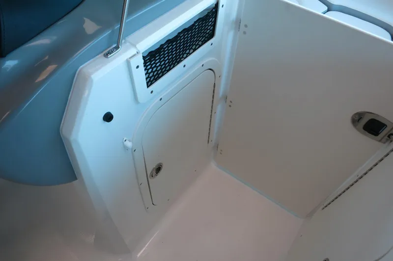 Slide: The Image of 2024 Chaparral 23 SSi OB boat interior storage compartment. - 15