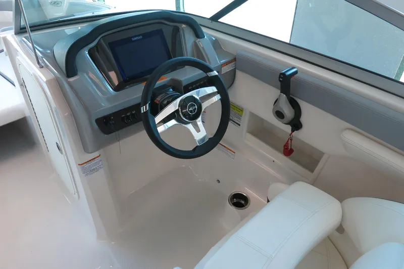 Slide: The Image of 2024 Chaparral 23 SSi OB boat cockpit with modern steering and controls. - 17